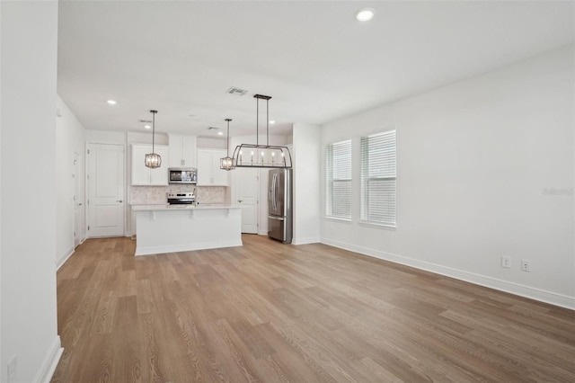 16484 Silver Brook Way, Winter Garden, FL 34787 - unfurnished living room featuring light wood-style floors, recessed lighting, baseboards, and a chandelier