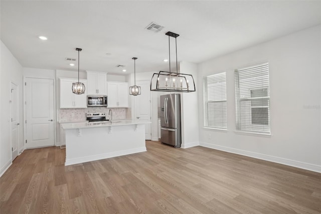 16484 Silver Brook Way, Winter Garden, FL 34787 - kitchen with stainless steel appliances, a chandelier, a sink, light wood-style flooring, and light countertops