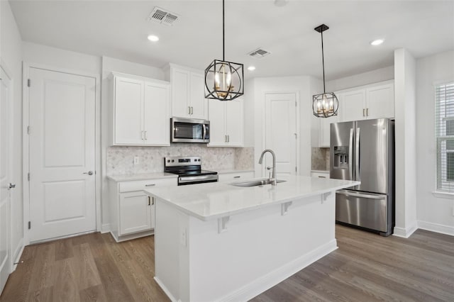 16484 Silver Brook Way, Winter Garden, FL 34787 - kitchen featuring appliances with stainless steel finishes, a sink, a chandelier, dark wood finished floors, and recessed lighting