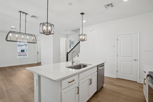 16484 Silver Brook Way, Winter Garden, FL 34787 - kitchen with a sink, appliances with stainless steel finishes, a chandelier, light wood finished floors, and light countertops