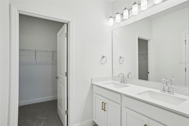 16484 Silver Brook Way, Winter Garden, FL 34787 - bathroom featuring a walk in closet, double vanity, and baseboards