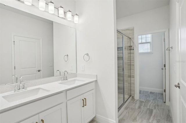 16484 Silver Brook Way, Winter Garden, FL 34787 - bathroom featuring a shower stall, double vanity, marble look tiles, and baseboards