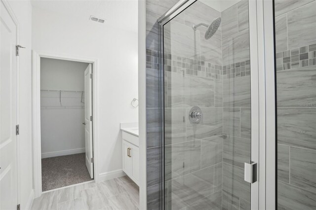 16484 Silver Brook Way, Winter Garden, FL 34787 - full bathroom featuring a stall shower, a walk in closet, vanity, and baseboards