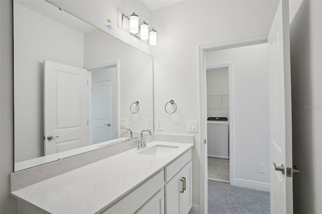 16484 Silver Brook Way, Winter Garden, FL 34787 - bathroom featuring washer / clothes dryer, vanity, and baseboards
