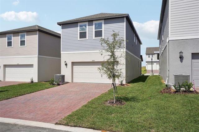 16484 Silver Brook Way, Winter Garden, FL 34787 - view of front of house with central air condition unit, a garage, decorative driveway, and a front yard