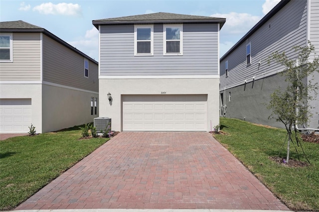 16484 Silver Brook Way, Winter Garden, FL 34787 - view of front of property with central air condition unit, a garage, a front lawn, decorative driveway, and stucco siding