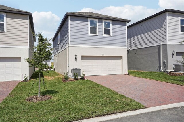 16484 Silver Brook Way, Winter Garden, FL 34787 - view of front of property featuring central AC unit, decorative driveway, an attached garage, stucco siding, and a front yard