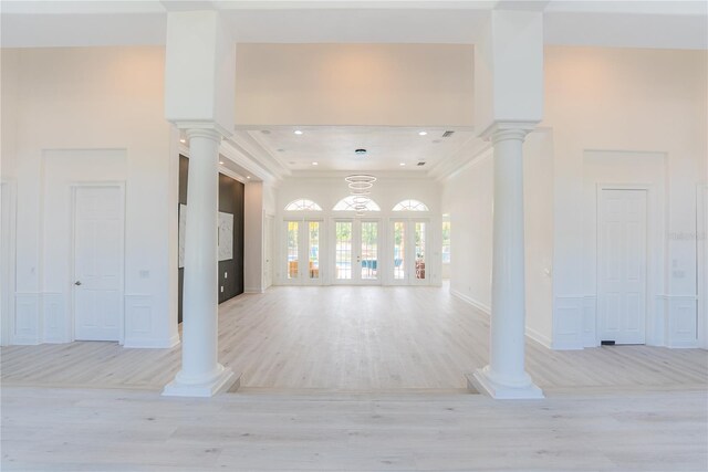 6550 Cartmel Ln, Windermere, FL 34786 - unfurnished living room featuring light wood finished floors, crown molding, and decorative columns