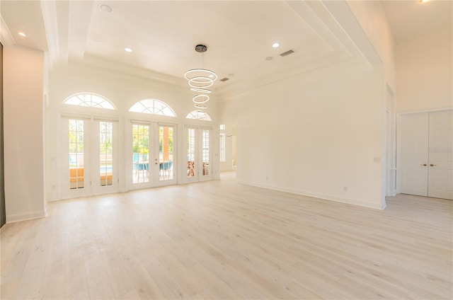 6550 Cartmel Ln, Windermere, FL 34786 - unfurnished living room with light wood-style flooring, french doors, and plenty of natural light