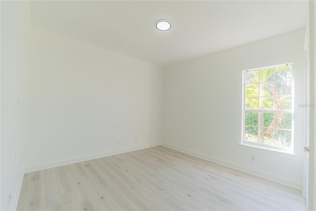 6550 Cartmel Ln, Windermere, FL 34786 - spare room with baseboards, light wood-style floors, and a healthy amount of sunlight