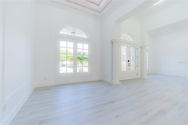 6550 Cartmel Ln, Windermere, FL 34786 - entrance foyer with ornamental molding, light wood-style floors, a decorative wall, and a towering ceiling