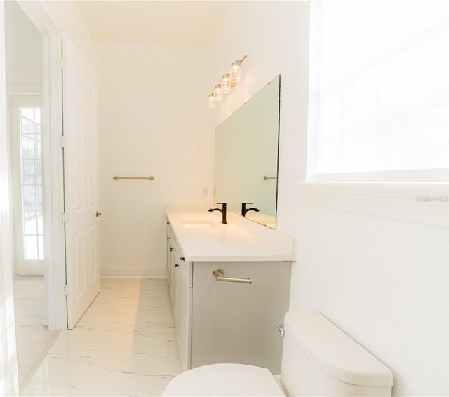 6550 Cartmel Ln, Windermere, FL 34786 - bathroom featuring toilet, marble finish floor, and vanity