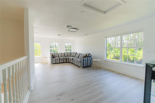 6550 Cartmel Ln, Windermere, FL 34786 - living room with attic access, a textured ceiling, baseboards, visible vents, and light wood-style floors