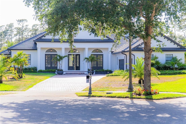 6550 Cartmel Ln, Windermere, FL 34786 - view of front of home with driveway, stucco siding, french doors, and a front yard