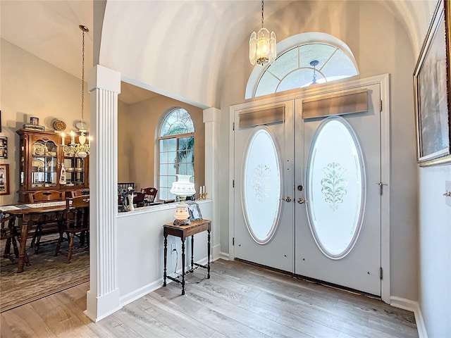 5060 NW 26th St, Ocala, FL 34482 - foyer entrance featuring french doors, wood finished floors, high vaulted ceiling, and a chandelier
