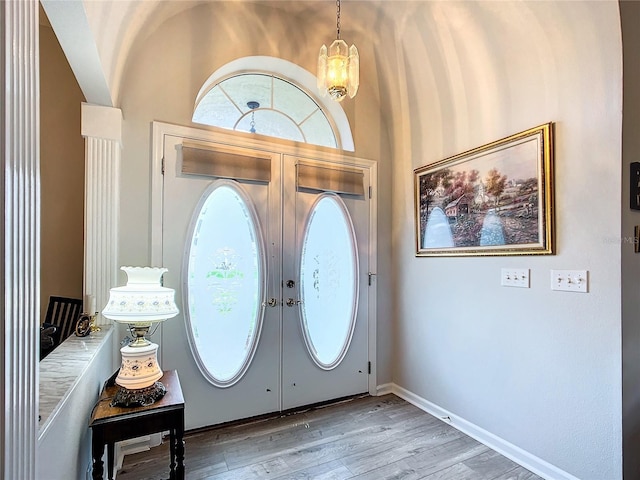 5060 NW 26th St, Ocala, FL 34482 - foyer with light wood-type flooring, french doors, an inviting chandelier, and baseboards