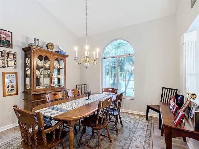 5060 NW 26th St, Ocala, FL 34482 - dining room with wood finished floors, an inviting chandelier, baseboards, and lofted ceiling