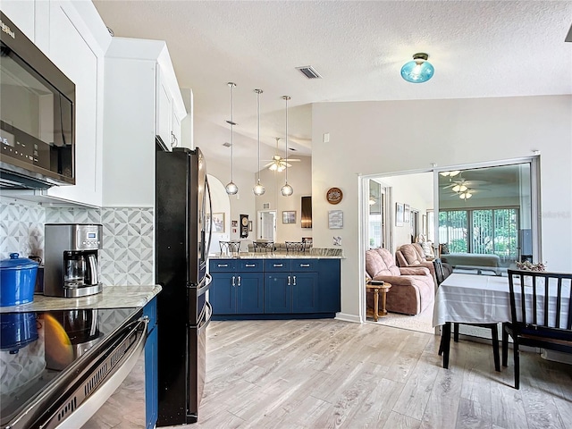 5060 NW 26th St, Ocala, FL 34482 - kitchen featuring black microwave, freestanding refrigerator, a ceiling fan, visible vents, and blue cabinets