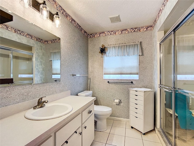 5060 NW 26th St, Ocala, FL 34482 - bathroom featuring visible vents, a textured ceiling, tile patterned flooring, vanity, and a stall shower