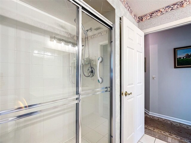 5060 NW 26th St, Ocala, FL 34482 - full bathroom featuring a shower stall, a textured ceiling, baseboards, and tile patterned floors