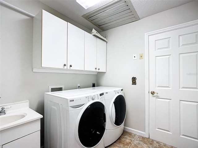 5060 NW 26th St, Ocala, FL 34482 - clothes washing area featuring light tile patterned floors, baseboards, separate washer and dryer, a sink, and cabinet space