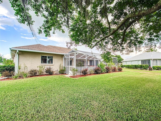 5060 NW 26th St, Ocala, FL 34482 - back of property with a yard, roof with shingles, a lanai, and stucco siding