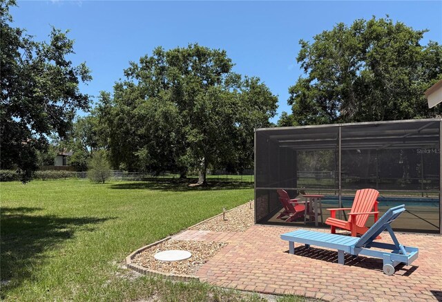 3652 Oak Grove Dr, Sarasota, FL 34243 - view of grassy yard with a pool, a patio area, and glass enclosure