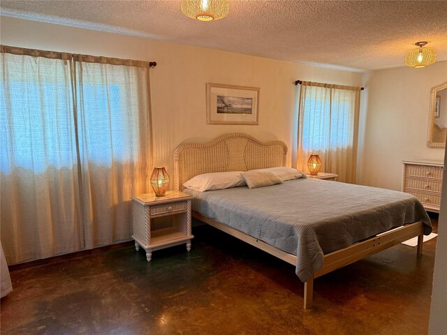 3652 Oak Grove Dr, Sarasota, FL 34243 - bedroom featuring finished concrete floors and a textured ceiling