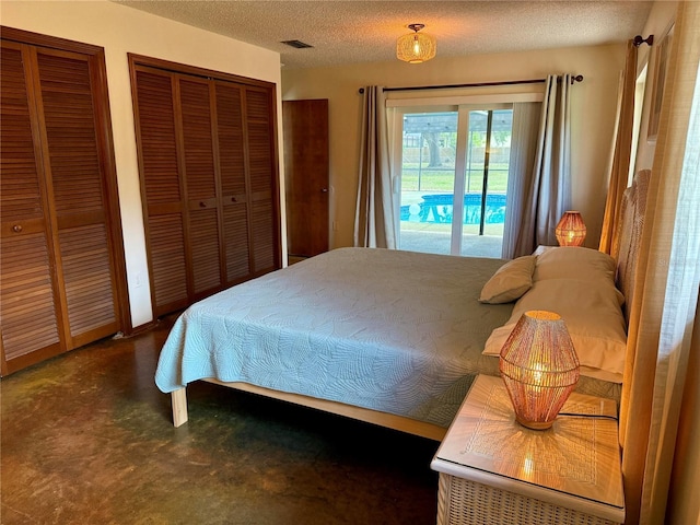 3652 Oak Grove Dr, Sarasota, FL 34243 - carpeted bedroom with access to outside, multiple closets, and a textured ceiling