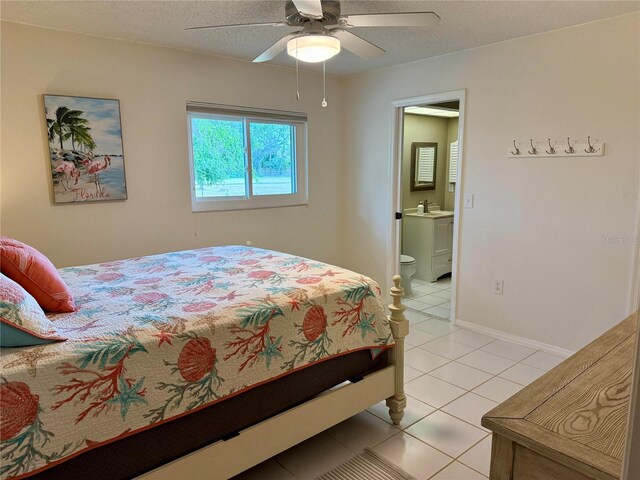 3652 Oak Grove Dr, Sarasota, FL 34243 - bedroom featuring light tile patterned floors, a sink, ensuite bath, a ceiling fan, and a textured ceiling