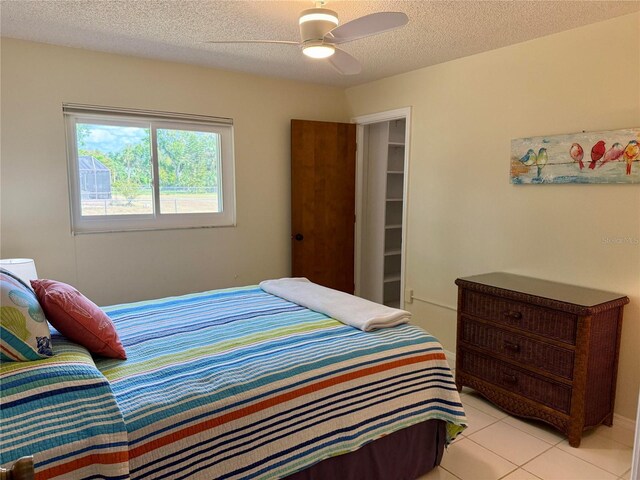 3652 Oak Grove Dr, Sarasota, FL 34243 - bedroom with a textured ceiling, light tile patterned flooring, and ceiling fan