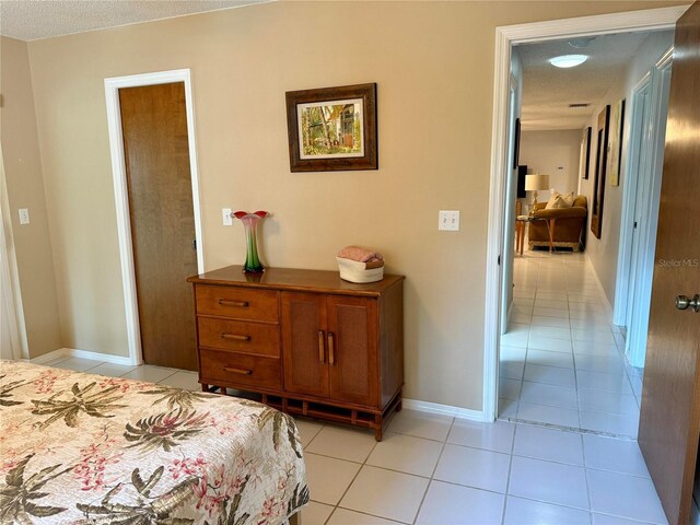 3652 Oak Grove Dr, Sarasota, FL 34243 - bedroom with light tile patterned flooring and baseboards