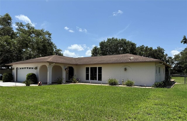 3652 Oak Grove Dr, Sarasota, FL 34243 - single story home with stucco siding, an attached garage, and driveway