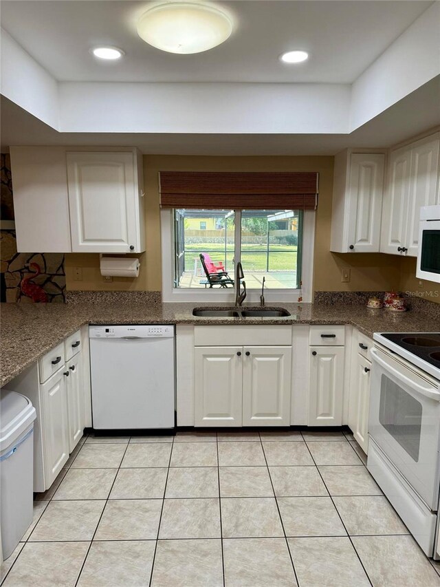 3652 Oak Grove Dr, Sarasota, FL 34243 - kitchen featuring white appliances, a sink, white cabinets, a tray ceiling, and recessed lighting