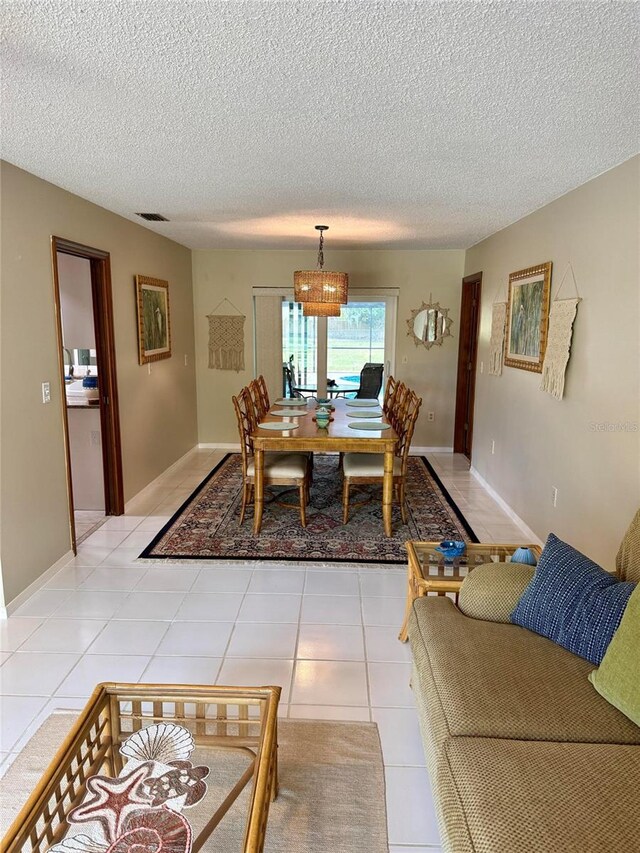 3652 Oak Grove Dr, Sarasota, FL 34243 - dining room with a textured ceiling, a chandelier, and light tile patterned floors