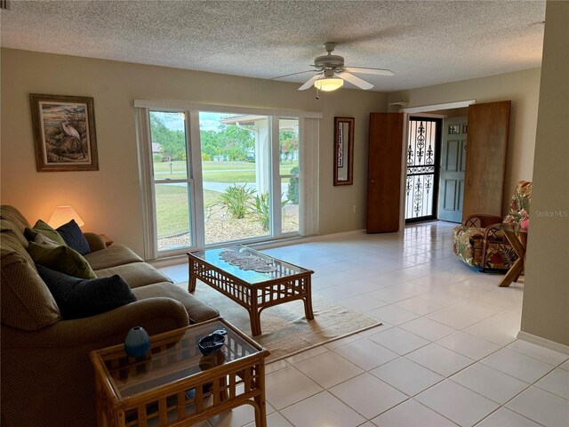 3652 Oak Grove Dr, Sarasota, FL 34243 - living room with a textured ceiling, ceiling fan, and light tile patterned floors