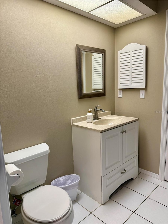 3652 Oak Grove Dr, Sarasota, FL 34243 - half bathroom featuring vanity, toilet, and tile patterned floors