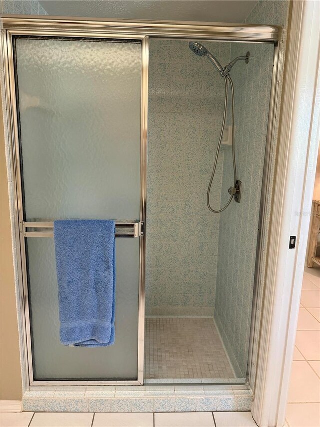 3652 Oak Grove Dr, Sarasota, FL 34243 - bathroom featuring a stall shower and tile patterned floors