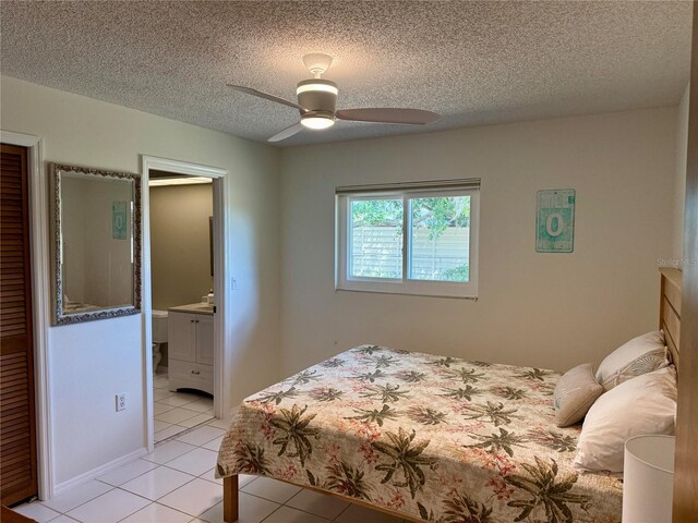 3652 Oak Grove Dr, Sarasota, FL 34243 - bedroom with a textured ceiling, light tile patterned flooring, ensuite bathroom, and a ceiling fan