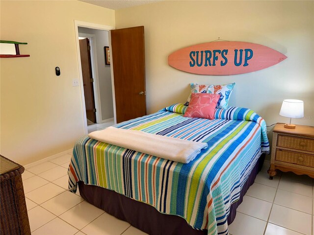 3652 Oak Grove Dr, Sarasota, FL 34243 - tiled bedroom featuring baseboards