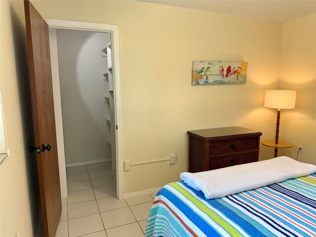 3652 Oak Grove Dr, Sarasota, FL 34243 - bedroom featuring light tile patterned flooring and baseboards
