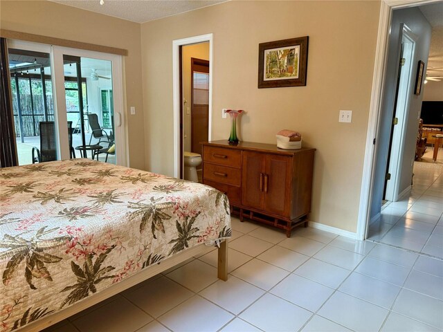 3652 Oak Grove Dr, Sarasota, FL 34243 - bedroom with light tile patterned floors, access to exterior, and baseboards