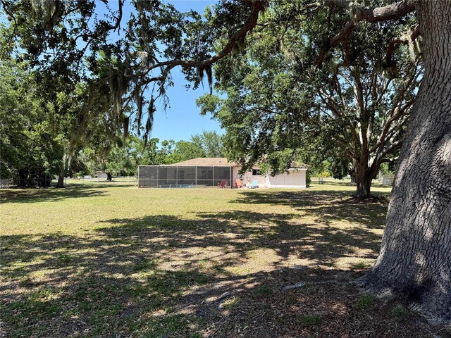3652 Oak Grove Dr, Sarasota, FL 34243 - view of grassy yard with a lanai