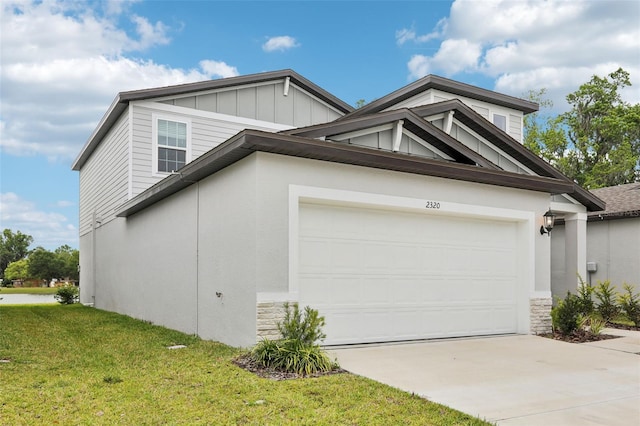 2320 E Newsome Rd, Plant City, FL 33565 - view of side of home featuring driveway, stone siding, a garage, board and batten siding, and a yard