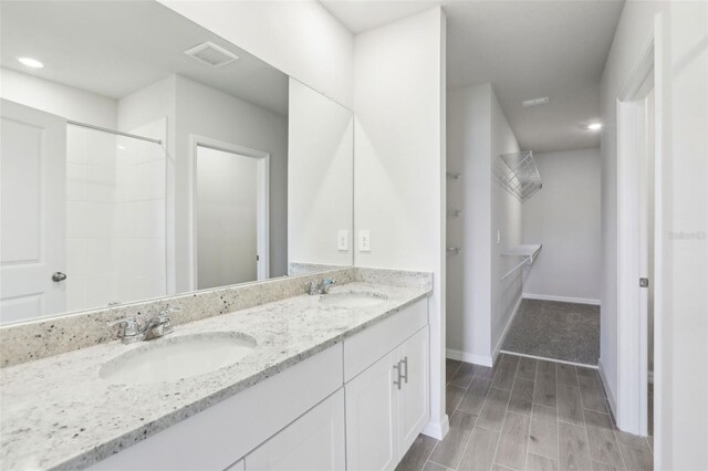 2320 E Newsome Rd, Plant City, FL 33565 - bathroom with wood finish floors, a sink, visible vents, and double vanity