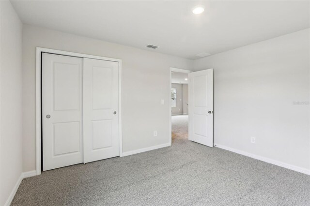 2320 E Newsome Rd, Plant City, FL 33565 - unfurnished bedroom with baseboards, carpet flooring, and visible vents