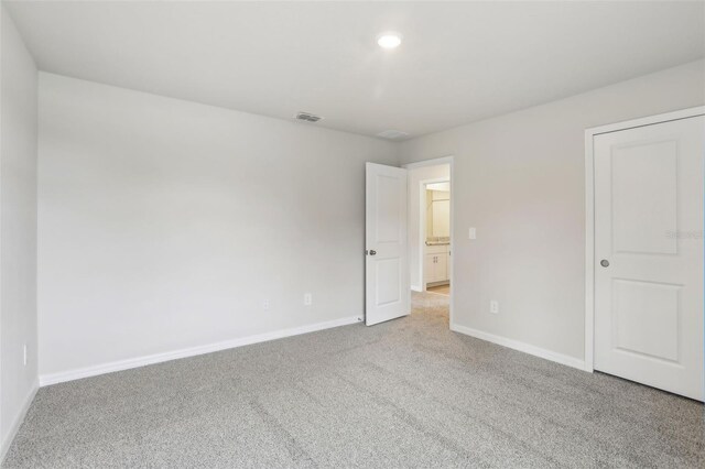 2320 E Newsome Rd, Plant City, FL 33565 - unfurnished bedroom with baseboards, carpet flooring, and visible vents