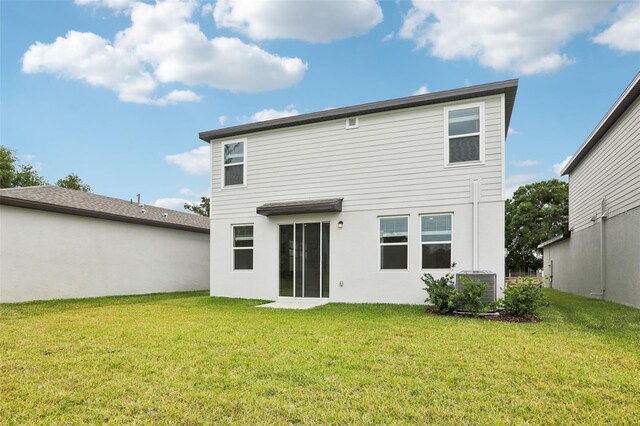 2320 E Newsome Rd, Plant City, FL 33565 - rear view of property featuring stucco siding, a yard, and central AC unit