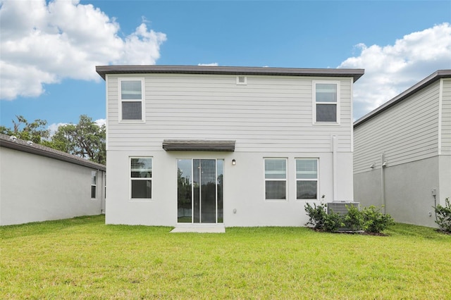 2320 E Newsome Rd, Plant City, FL 33565 - back of property with a lawn, central AC, and stucco siding