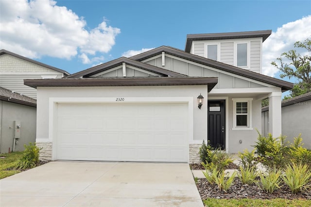 2320 E Newsome Rd, Plant City, FL 33565 - view of front of house with a garage, driveway, and stone siding